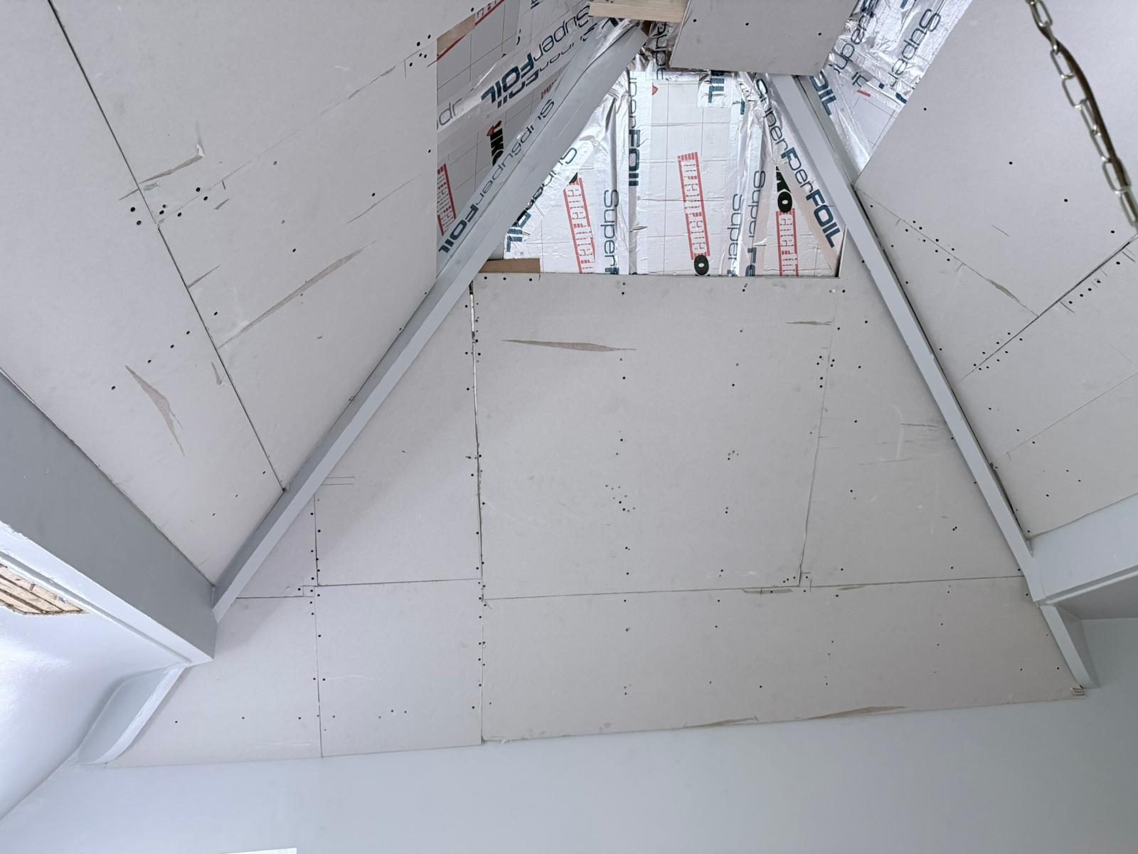 Plasterboard overboarding being fitted over the PIR-insulated rafters of garage extension, Far Headingley LS16