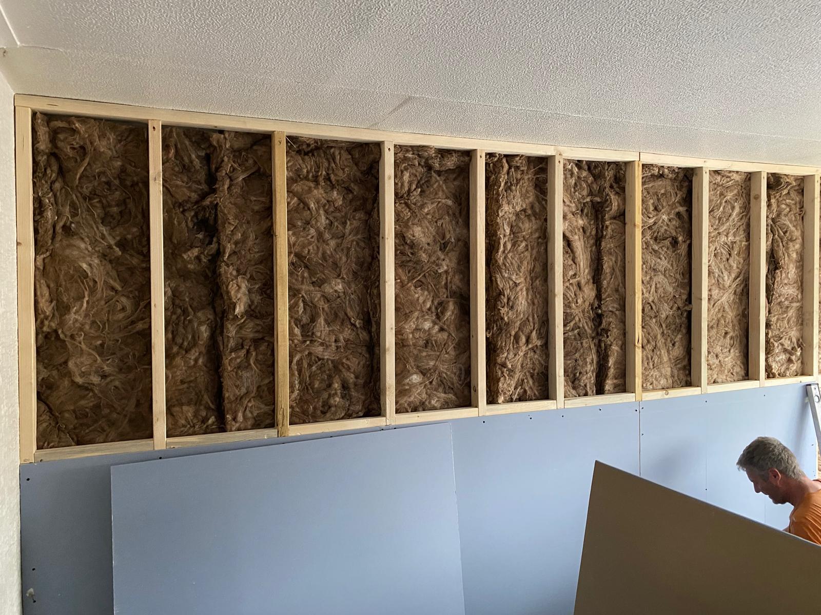 Independent stud frame packed with acoustic mineral wool, first soundproof boards going on — Rothwell LS26 bedroom