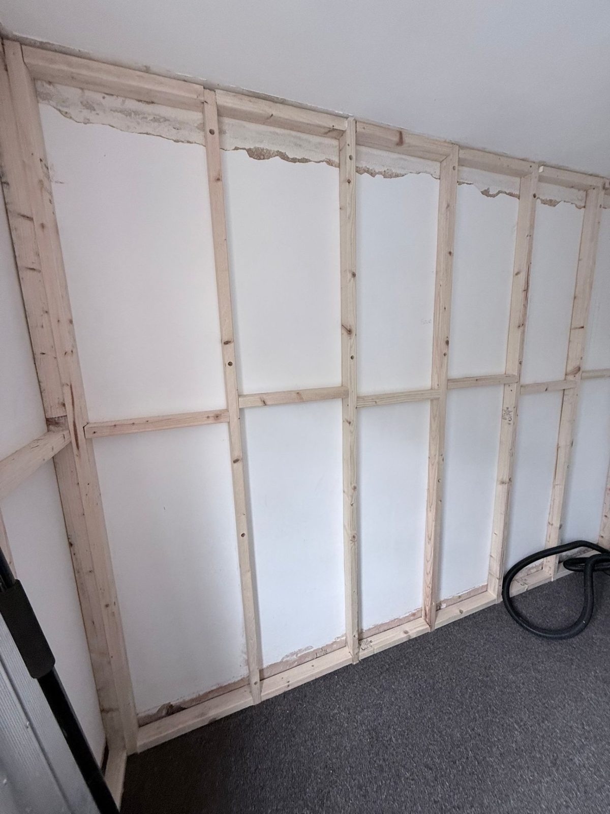 Timber batten frame fixed to external wall ready for PIR insulation — Wyncliffe Court, Roundhay LS17