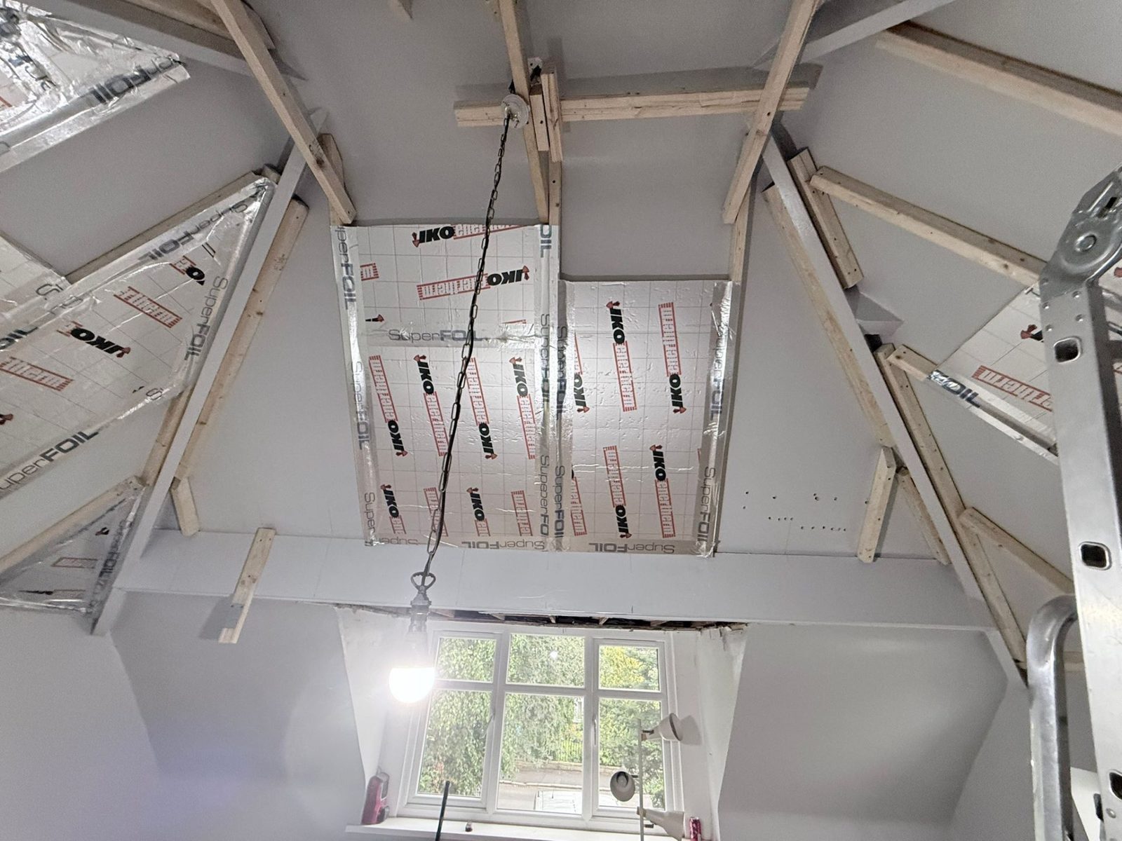 Battened-out rafters with first JIKO Enertherm PIR and SuperFOIL boards going in to vaulted garage extension ceiling — Far Headingley LS16