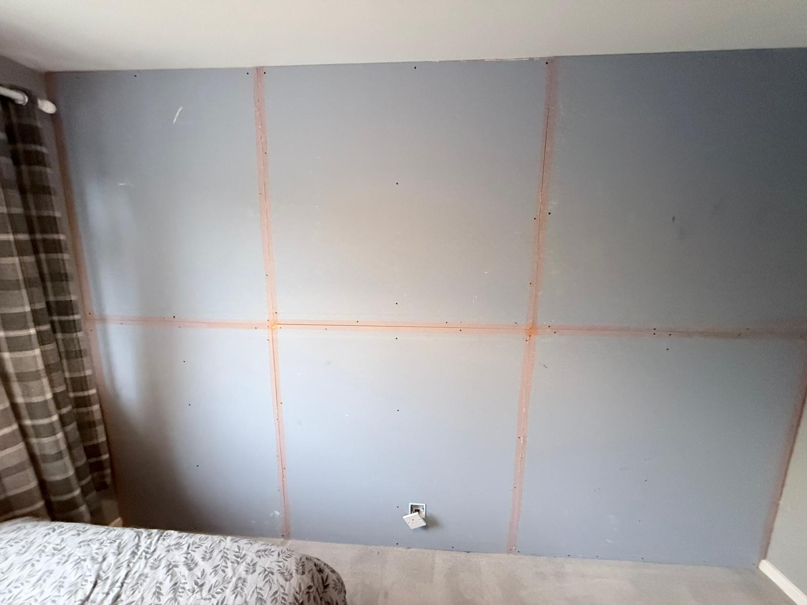 Soundproof acoustic plasterboard fitted to second bedroom wall with taped joints — Rothwell LS26