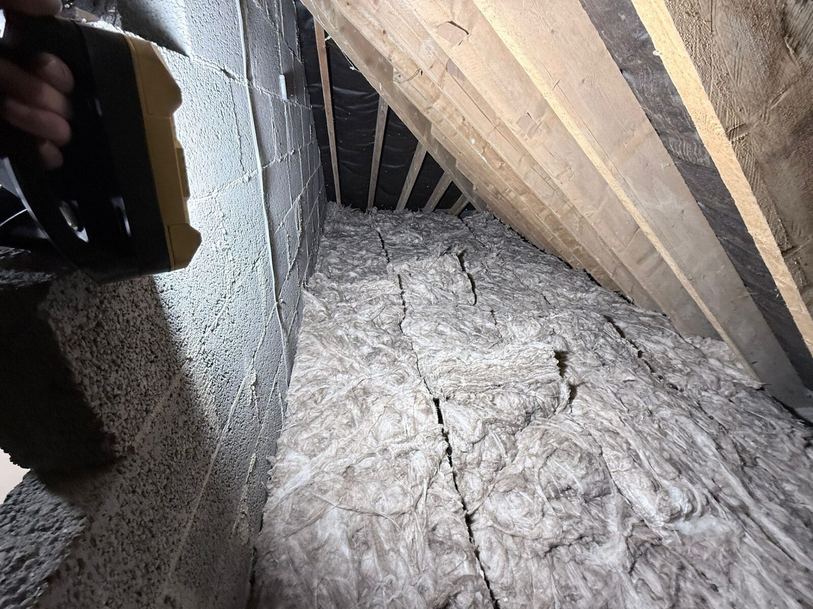Fresh mineral wool loft insulation laid between joists in Brighouse HD6