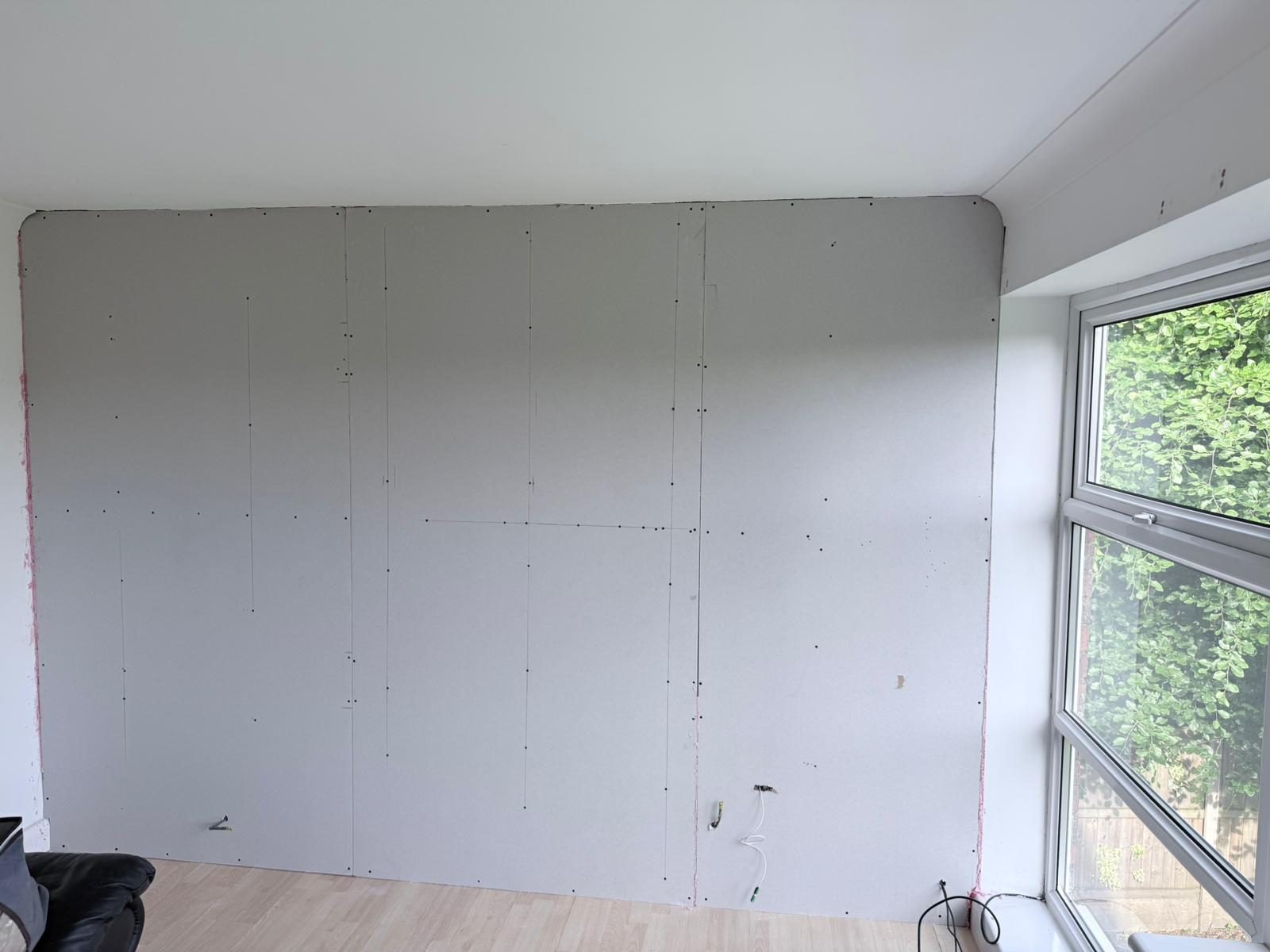 Plasterboard overboarding fitted over PIR insulation, ready for skim