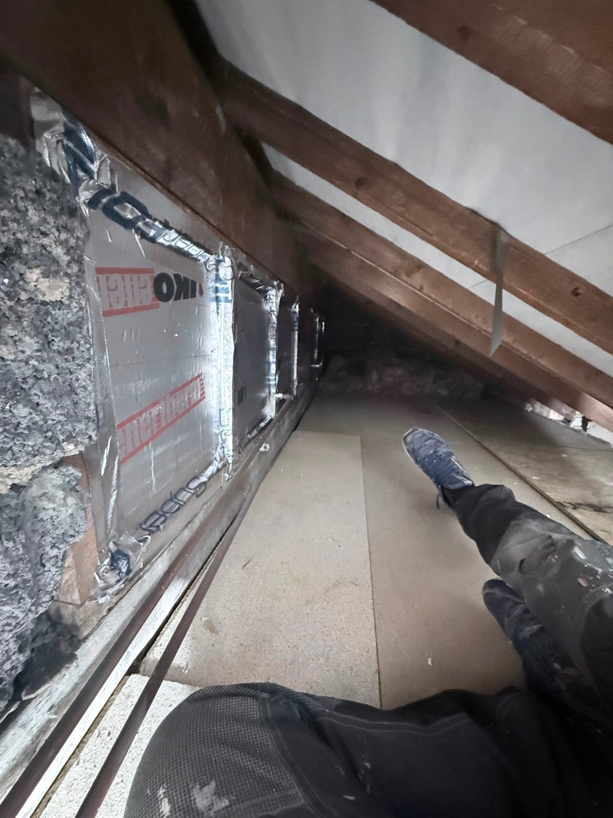 PIR insulation boards fitted between rafters with VCL foil tape sealing every seam in Bradford BD4 bedroom eaves