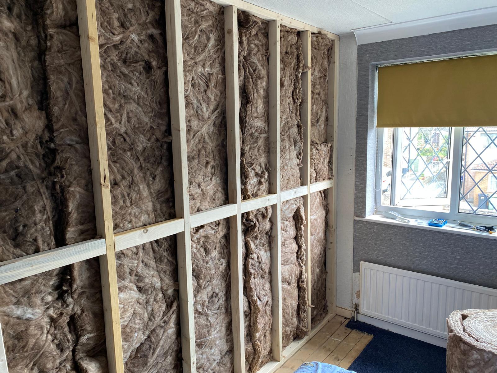 Full-height timber stud and acoustic mineral wool build-up in second bedroom, Rothwell LS26